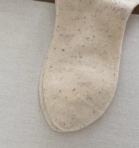Detailed view of women autumn retro flecked yarn mid-tube socks with cute embroidery.