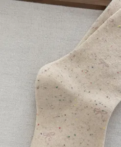 Close-up detail of retro nepp yarn women mid-tube socks with cute bow texture and warm fabric.