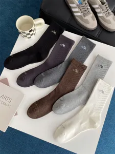 Men's casual cotton mid-tube socks with stylish snow mountain embroidery and ribbed design.
