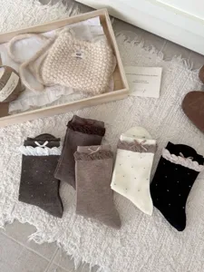 Japanese sweet polka dot mid-calf socks with delicate lace and bows for daily wear.