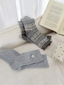 Cozy knit mid-tube women socks, retro Fair Isle pattern and light blue heart patch detail.