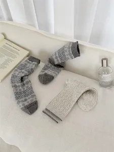 Detailed shot of retro Fair Isle knit mid-tube socks, cozy daily style, soft textured fabric.