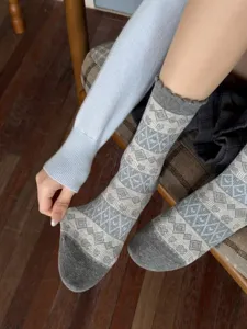 Detail view of vintage fair isle patterned women mid tube socks in grey and blue.