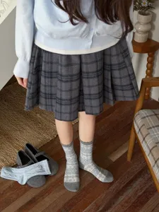 Detail view of grey retro fair isle patterned mid-tube socks, cozy chic daily look.