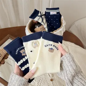 Japanese style navy blue and beige cartoon bear mid-tube socks with cute rolled cuffs.