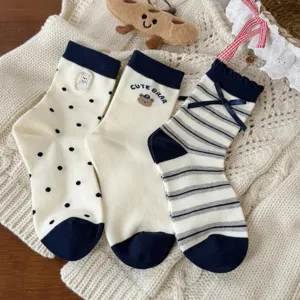 Cute Japanese style women mid-tube socks with bear embroidery and bow detail, soft knit fabric.