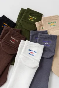 Detailed view of trendy cotton socks featuring chic letter embroidery in various bright colors.