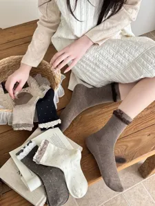Japanese sweet style women mid-tube socks with cute lace bow and polka dots design detail.