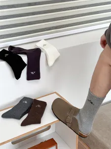 Men's cotton mid-tube socks with snow mountain embroidery, casual street style detailed view.