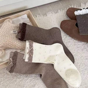 Japanese sweet polka dot mid-tube socks with cute lace ruffles and bowknot details for daily wear.