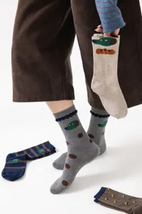 Detail view of cute cartoon dog patterned cotton mid-calf socks with playful illustrations.