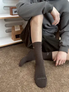 Men brown mid tube cotton socks featuring snow mountain graphic and stylish text knit detail.