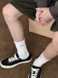 Men's white cotton mid-tube socks with trendy snow mountain embroidery for street style daily wear.