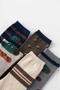 Detailed view of cute cartoon crocodile and striped cotton mid-tube socks, soft and comfy.