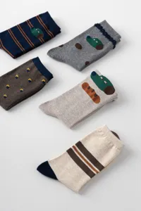 Cute cartoon designer crew socks detail view, soft cotton knit material with funny pattern.