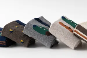 Detail view of funny cartoon cotton mid-calf socks, showing fine knit and cute animal pattern.