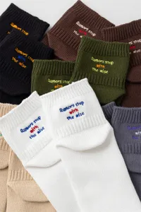 Detailed shot of trendy men embroidered crew socks in multiple colors with cotton fabric.