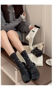 Grey women mid tube socks detail showcasing cute bow and delicate floral pattern design.