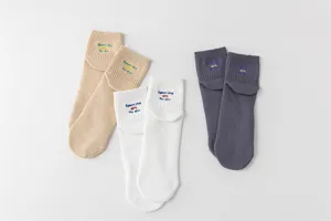 Detailed view of embroidered cotton short socks in various colors, showcasing cuff design.