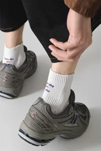 Men's cotton crew socks with stylish letter embroidery, ribbed design, comfortable and breathable.