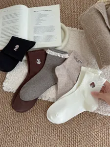 Sweet Japanese style embroidered mid-calf socks with lace trim and cute cartoon motifs.