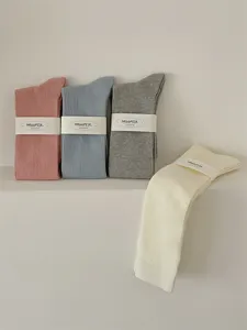 Detailed view of women's ribbed long cotton socks in cozy pastel colors, soft and stylish.