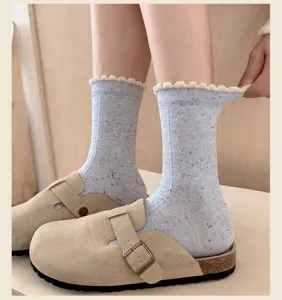 Detailed view of the Korean style speckled yarn mid-tube socks with cute ruffle lace cuffs.