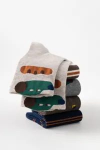 Close-up detail view of cute cartoon patterned cotton mid-calf socks stacked neatly.