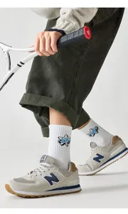 Detailansicht der atmungsaktiven Baumwoll-Sportsocken im Mittelschnitt mit Sneakers.