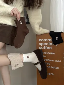 Detailed shot of cute Japanese style embroidered mid-tube cotton socks with sweet lace.