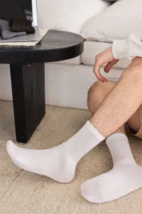 Men cotton crew socks detail shot showing comfortable ribbed design and breathable white fabric.