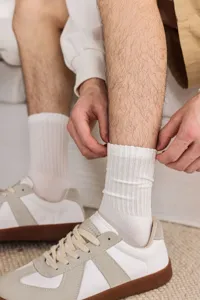 Men's casual ribbed white cotton mid-tube socks close-up view showing comfortable fit.