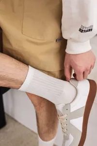 Men's casual white cotton ribbed crew socks detail shot showing breathability and comfort.