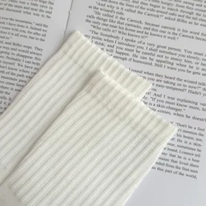 White ribbed cotton men's socks close-up view, showing breathable texture and fine knit detail.