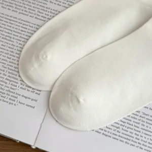 Detailed view of white cotton men socks, breathable knit texture for business casual wear.