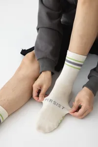 Men's athletic crew socks with striped design and seamless comfort, detailed view.