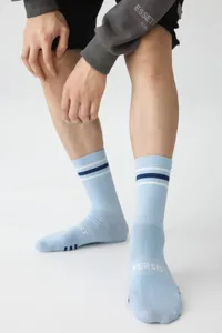 Men athletic crew socks in light blue with stylish two-stripe design and text detail.