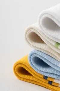 Men's athletic mid-tube cotton socks detail shot showcasing colorful stripe knit texture.