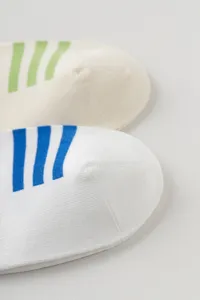 Close-up detail view of athletic cotton socks featuring stylish contrast stripes.