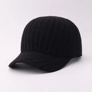 Detailed close-up of a black knitted baseball cap, soft winter warm woolen hat texture.