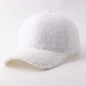 Detail view of white sherpa fleece baseball cap, soft texture and warm design for winter.