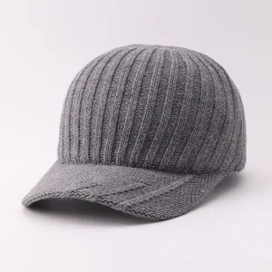 Close-up detail of the knitted texture and curved brim on this grey winter baseball cap.