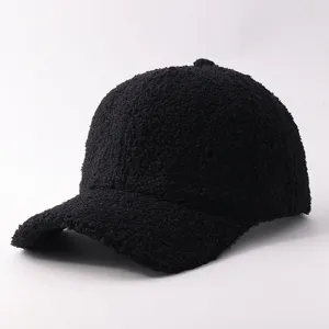 Close-up detail of black sherpa baseball cap, cozy fuzzy plush texture, warm winter hat.
