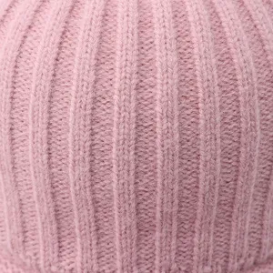 Detailed close-up view of soft pink knit texture warm winter baseball cap fabric material