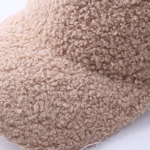 Detailed view of winter warm teddy fleece baseball cap, cozy sherpa fabric texture.