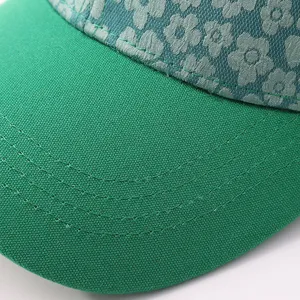Green floral baseball hat detail view, women's fashion casual sun protection cap.