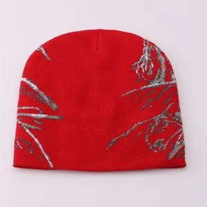 Red knitted beanie hat with stylish silver grey pattern, warm winter pullover cold hat detail.