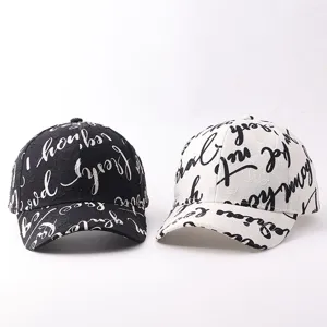Detailed shot of trendy graffiti letter baseball caps in black and white styles, casual sun hats.