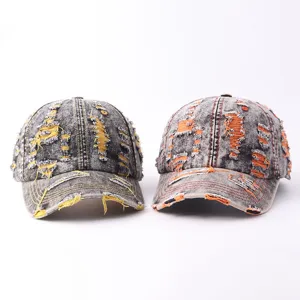 Close-up display of distressed denim baseball caps featuring colorful frayed edges and soft fabric.