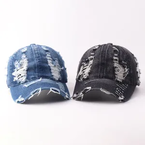 Detailed view of distressed denim baseball caps in blue and dark grey with vintage style.